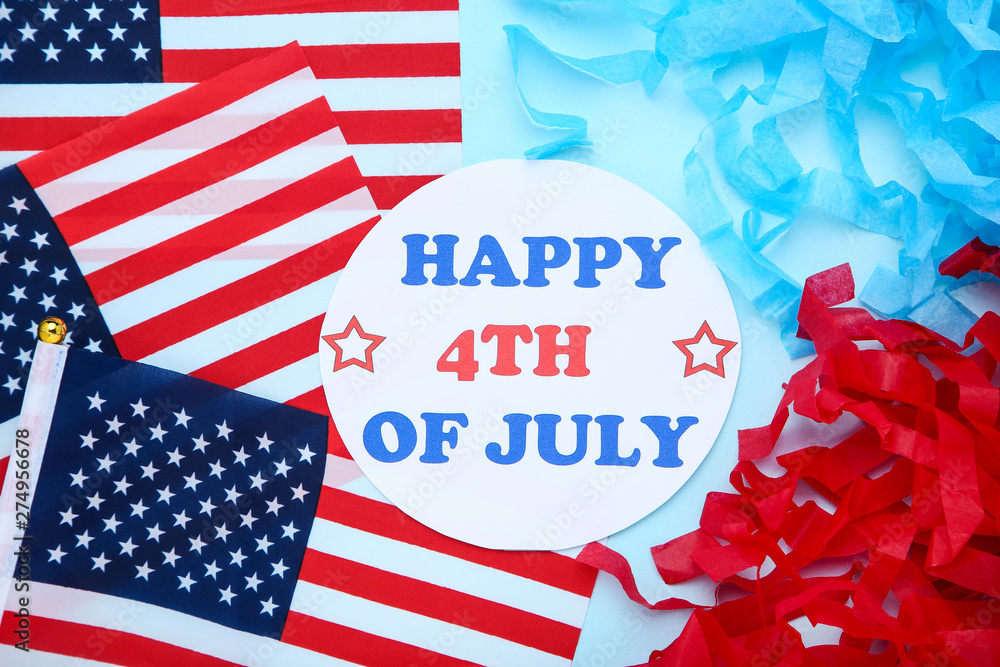 Fototapeta premium Text Happy 4th of July with american flags on blue background