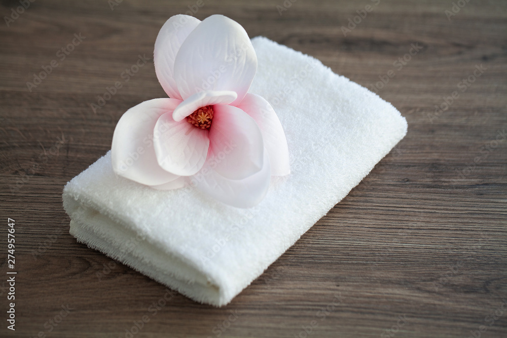 Spa orchid with soft towels on wooden table Spa orchid with soft towels on wooden table