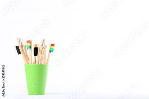 Bamboo toothbrushes in basket isolated on white background