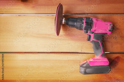 Schilderij op canvas One power tool with a sander is laying on a wooden surface