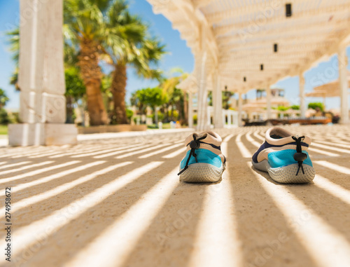 swimmimg shoes under shadows from suncover roof photo