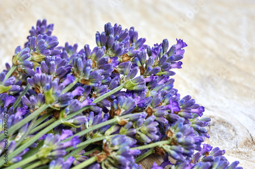 Lavender flowers in deep purple or lilac on old weathered wooden background with copy space 