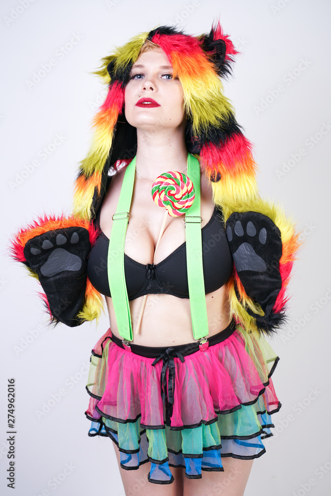 pretty colorful fashion female in fur bear hat ready for freak summer party on white studio background isolated alone pretty colorful fashion female in fur bear hat ready for freak summer party on white studio background isolated alone
