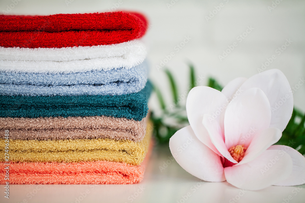 Towels and a branch of an orchid on a white background. Aromatherapy. Spa and Hygiene Towels and a branch of an orchid on a white background. Aromatherapy. Spa and Hygiene