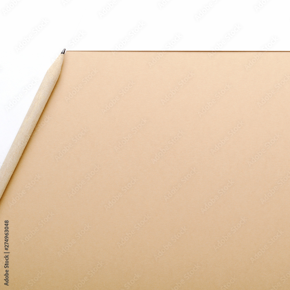 Beige pencil on a beige and white background. Concept office desk, business. Top view, flat lay, copy space. Beige pencil on a beige and white background. Concept office desk, business. Top view, flat lay, copy space.