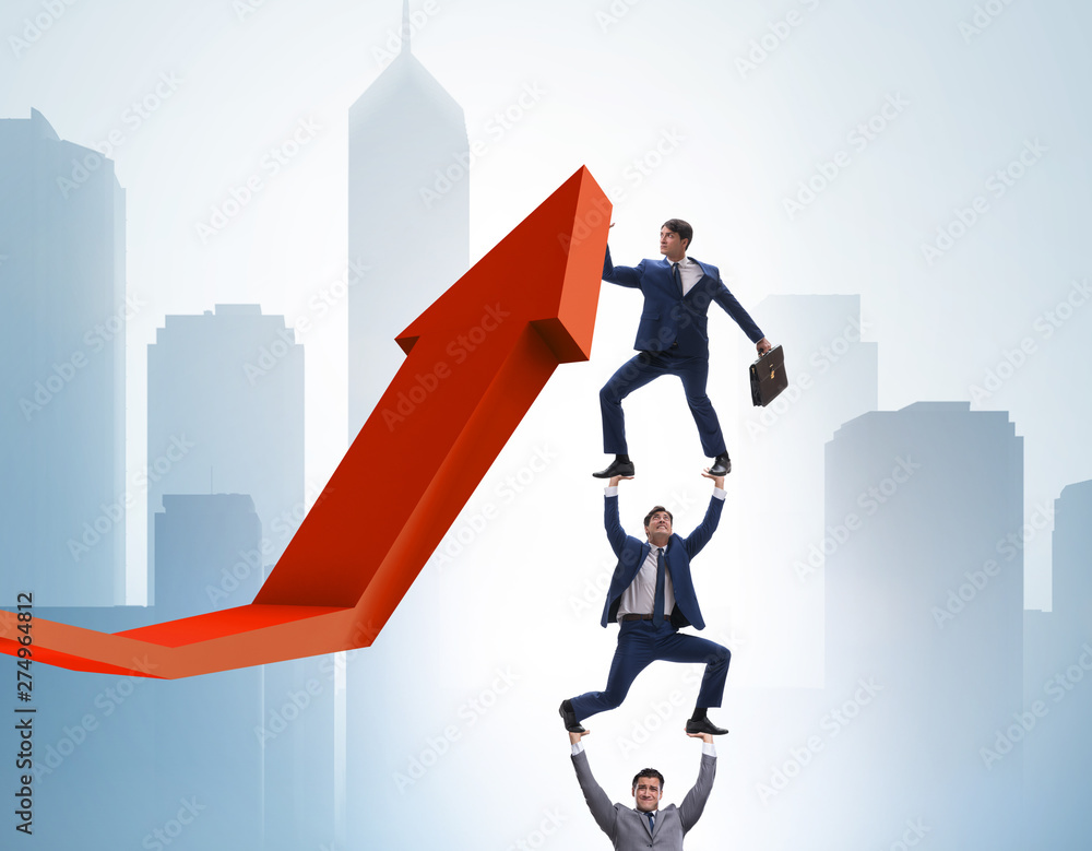 Businessman supporting growtn in economy on chart graph Businessman supporting growtn in economy on chart graph