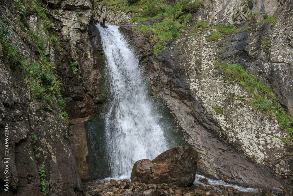 Closeup view of waterfall scenes in mountains, national park Dombay, Caucasus