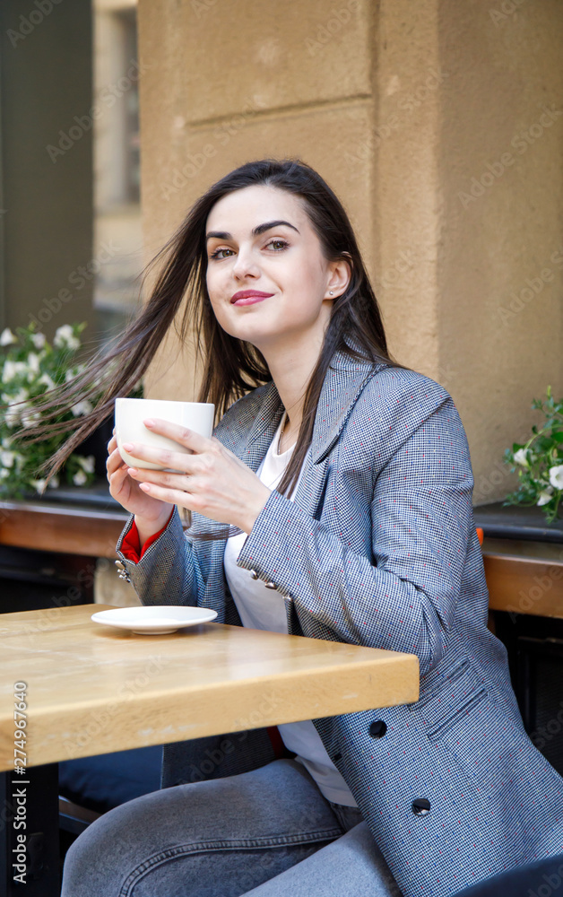 Young business woman having a coffee break at the street cafeteria Young business woman having a coffee break at the street cafeteria