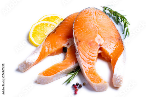 Slice of red fish salmon with lemon, rosemary isolated on white background with path .