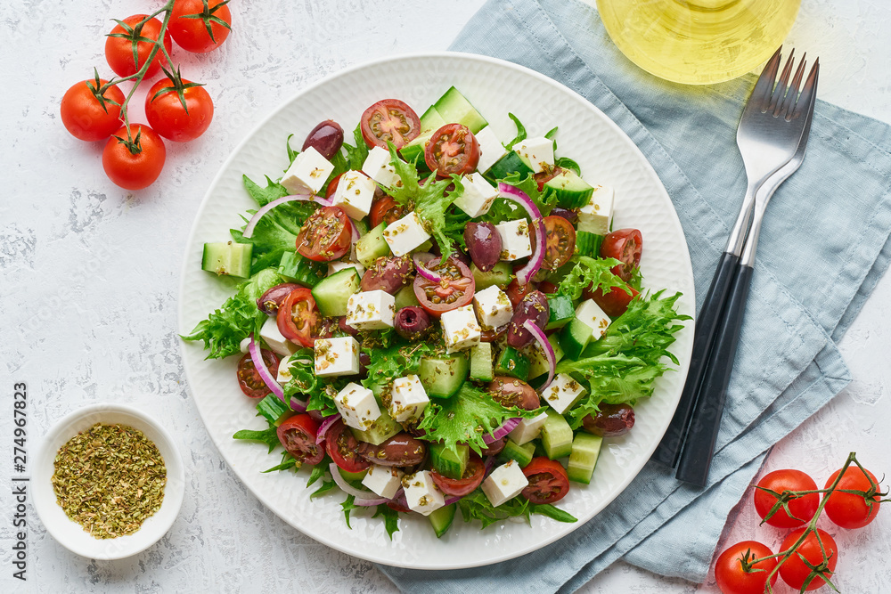 Greek Salad with feta and tomatoes, dieting food on white background top view