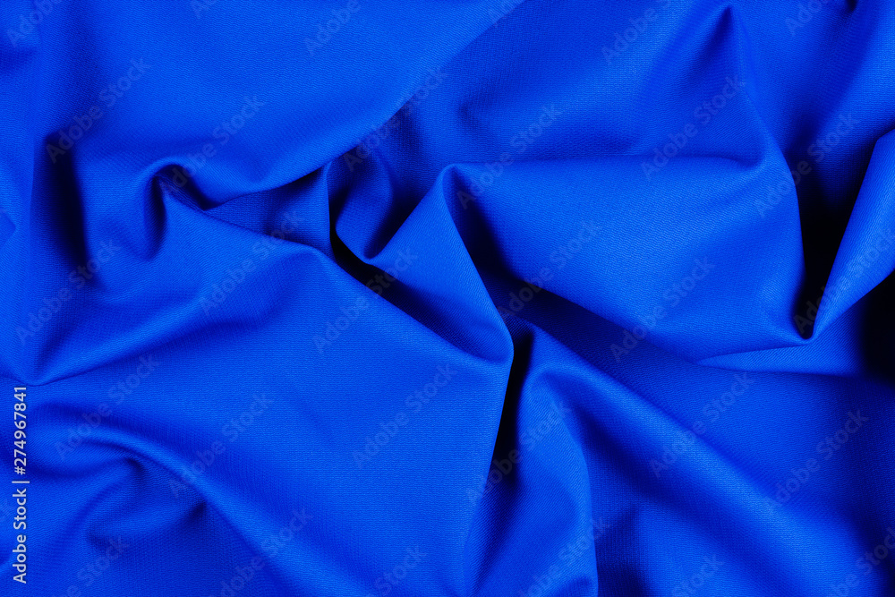 Bright blue fabric texture with folds. Bright blue fabric texture with folds.