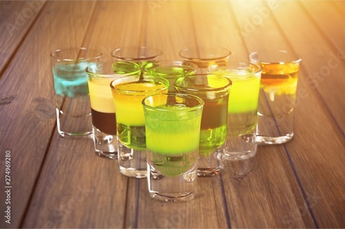 Colourful shot drinks on a white background with reflections photo