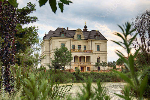 WROCLAW, POLAND - JUNE 21, 2019: Palace in Biskupice Podgorne near Wroclaw, Poland. Cloudy sky on the last day of spring. photo