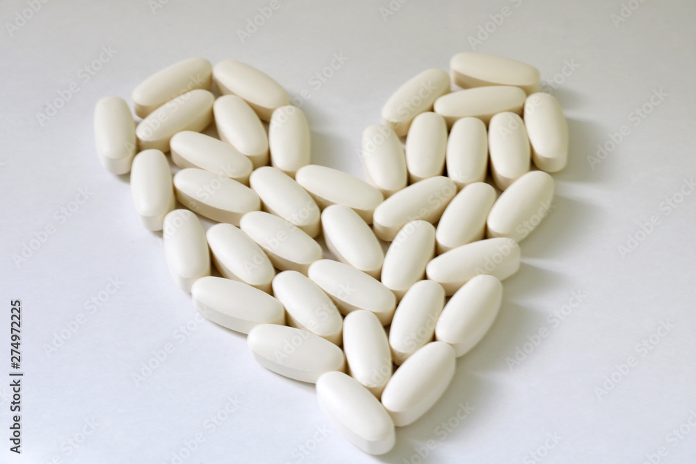 Pills medicine in the shape of heart, isolated on white background Pills medicine in the shape of heart, isolated on white background