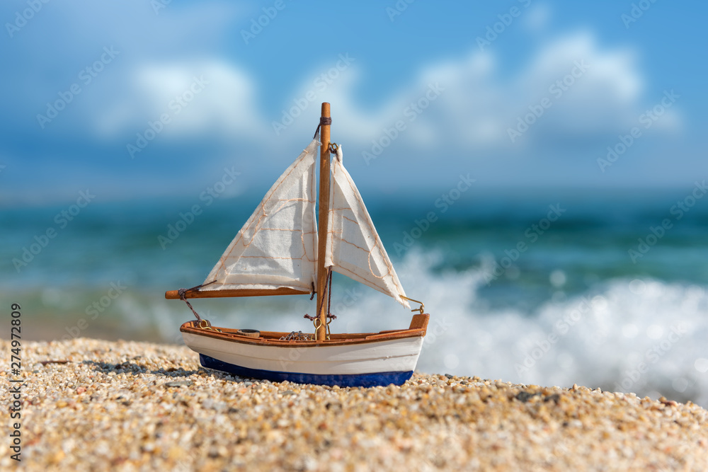 Miniature fishing boat at beach - obrazy, fototapety, plakaty 