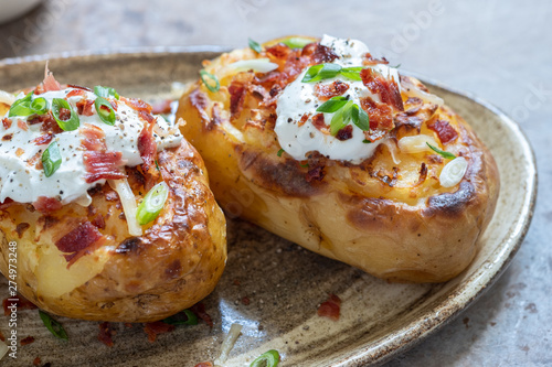 Canvas Print Baked loaded potato with bacon, cheese, sour cream and onion