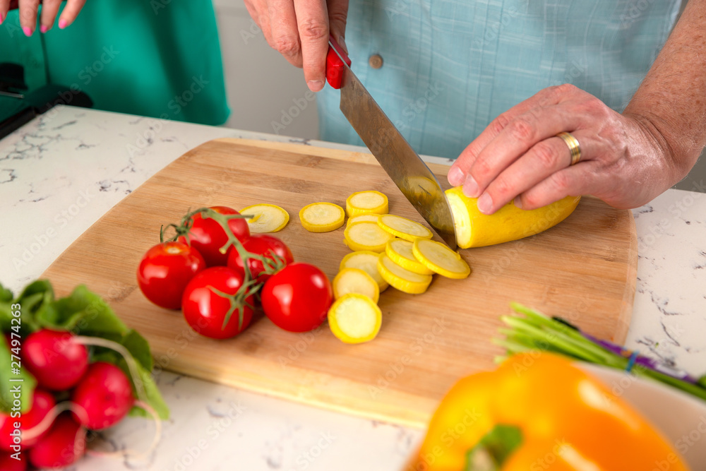 Close up of home cooking cutting board with tomatoes, squash zucchini, vegetarian meal Close up of home cooking cutting board with tomatoes, squash zucchini, vegetarian meal