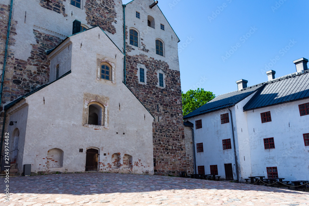 The courtyard and the entrance to the historic medieval castle-fort Abo in the city of Turku in Finland on a sunny summer day.