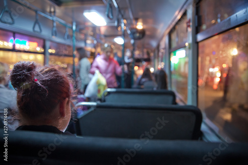 People in old public bus, view from inside the bus . People sitting on a comfortable bus in Selective focus and blurred background. s the main mass transit passengers in the bus.