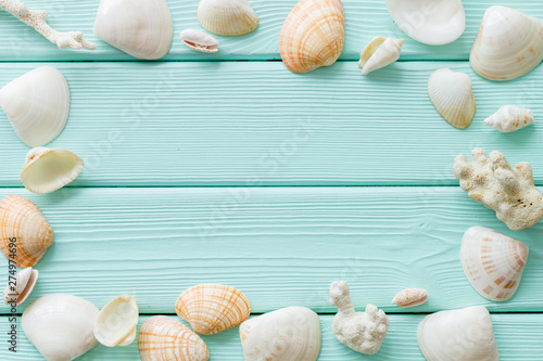 shells frame and seaside background for blog or desktop on mint green wooden table top view mockup