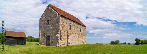 Looking at the nave of St Peter's 7th-century chapel, Bradwell-on-Sea, built of reused Roman materials on the entrance of Othona Roman fort