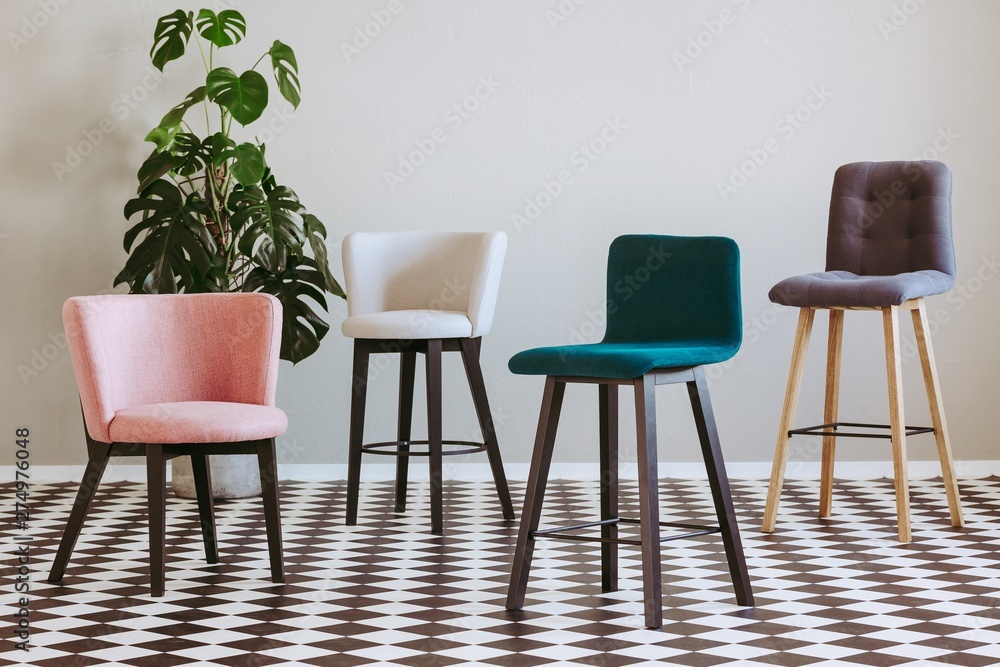 Obraz premium Fashionable colorful chairs in elegant interior with black and white floor