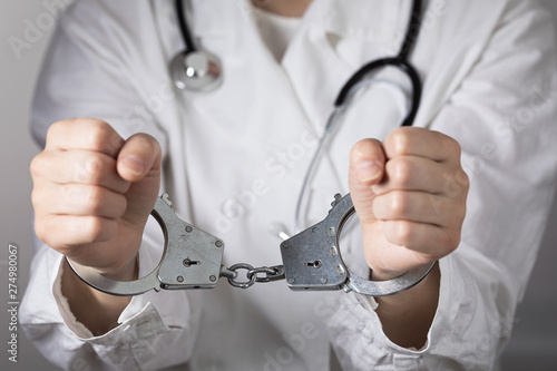 Bild auf Leinwand The handcuffed doctor. Concept on the topic of medical negligence