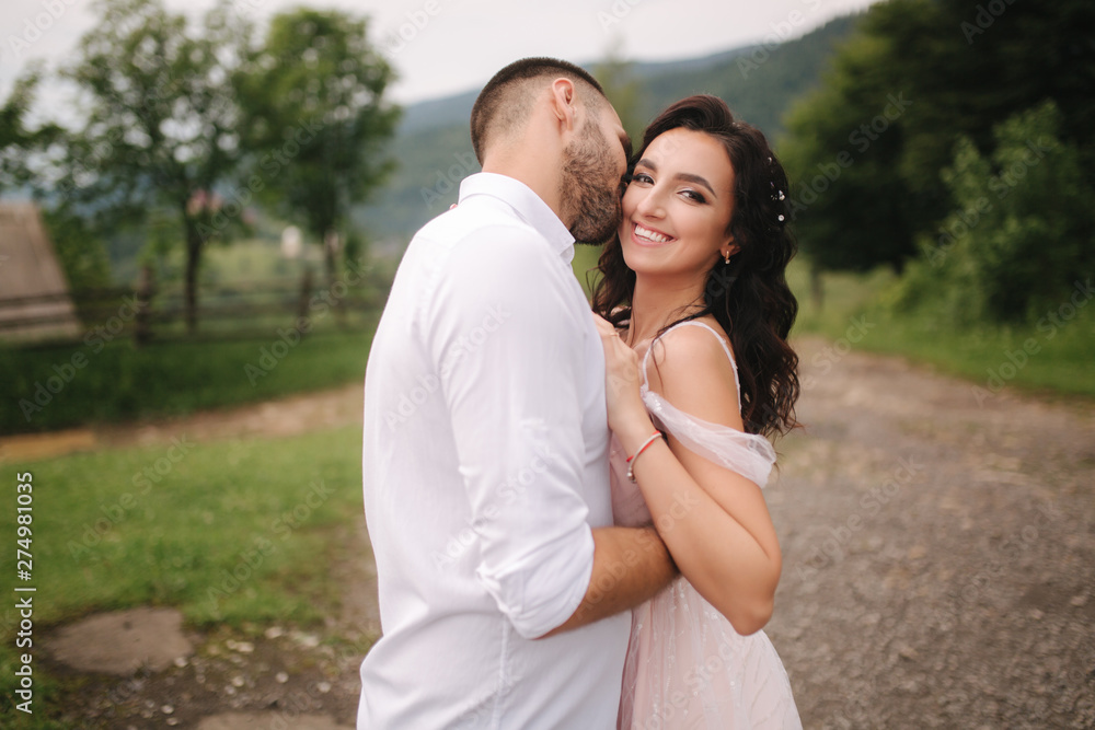 Beautiful wedding couple in Carpathian mountains. Handsome man with attractive woman Beautiful wedding couple in Carpathian mountains. Handsome man with attractive woman