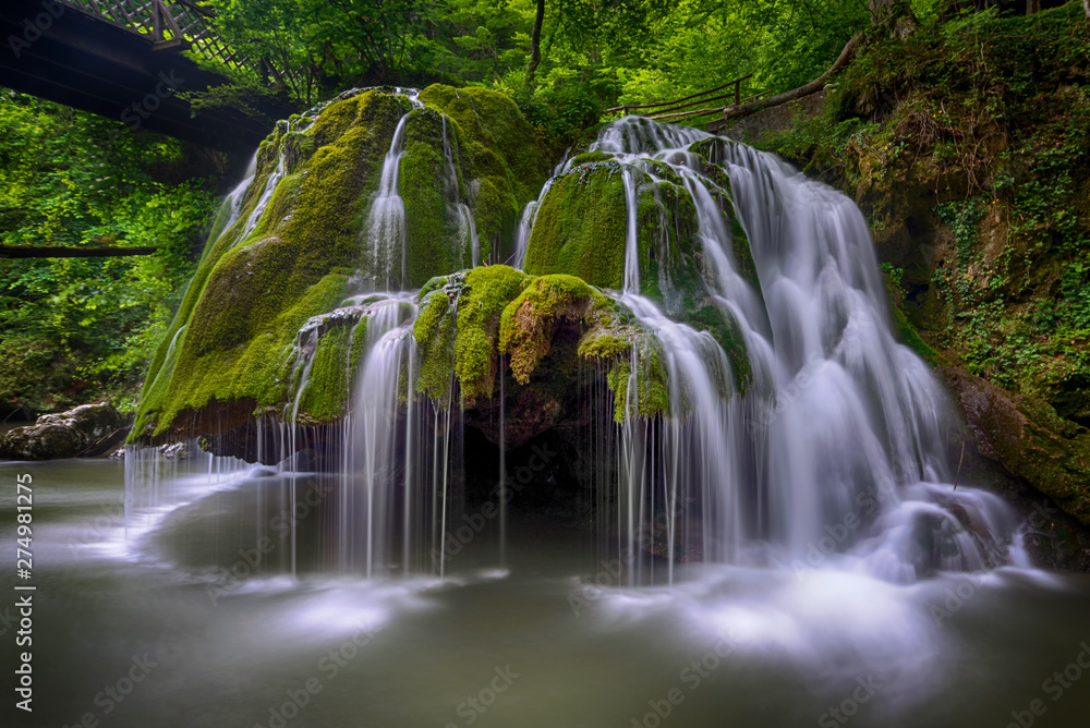 Long exposure image of Bigar Falls from Romania. This is considered one of the most beautiful waterfalls from the world - obrazy, fototapety, plakaty 