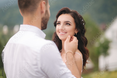 Close up portrait of beautiful couple in mountains. Happy woman with man. Elegant female with her husband