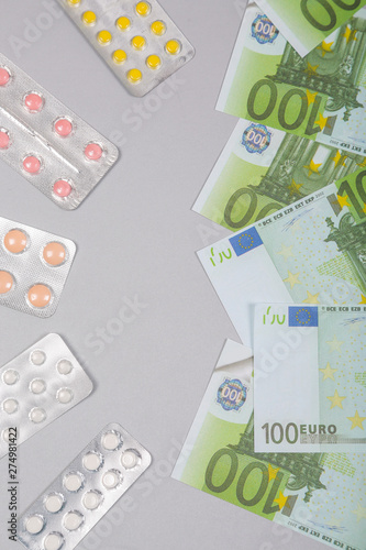 Money euro banknotes and pills. Expensive medical services