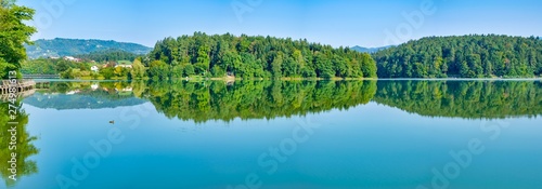 panoramic view of the lake with green trees and empty sky in slovenia. Empty background