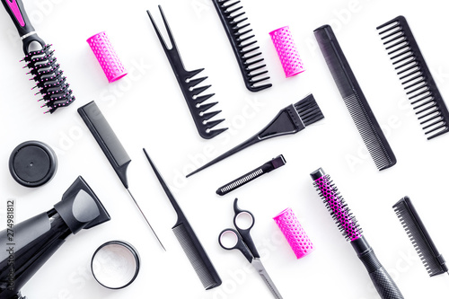 Fototapeta Naklejka Na Ścianę i Meble -  Set of professional hairdresser tools with combs, drier and sciccors on white background top view pattern