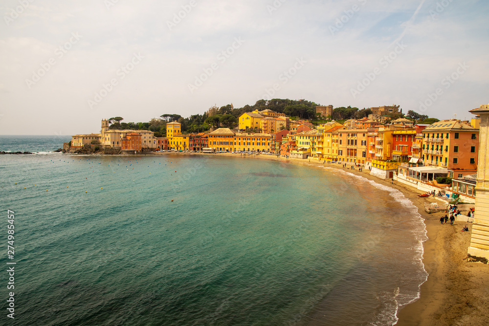 High angle view of the famous Bay of Silence, also called Portobello, in the ancient fishing village of Sestri Levante with the typical colored houses leaned out on the sandy beach, Liguria, Italy