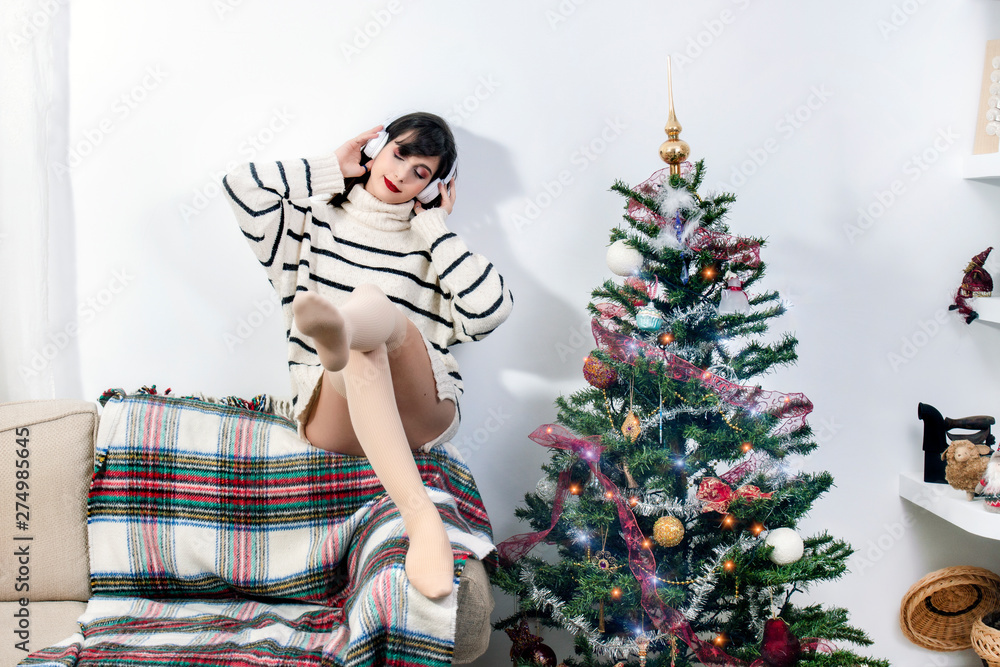 Young girl on sofa with headphones Young girl on sofa with headphones