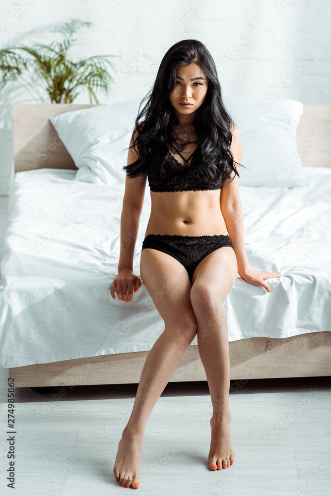 sexy thai woman in lace black lingerie sitting on bed at home Stock Photo |  Adobe Stock