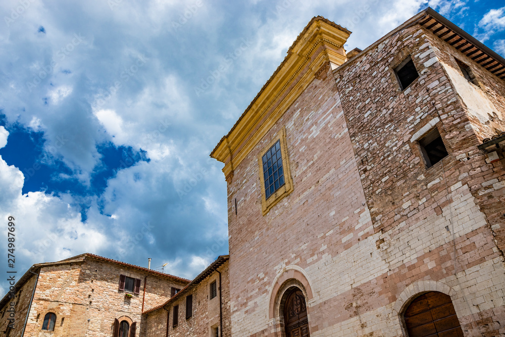 The Franciscan church of Sant'Andrea. The stone and brick houses. In Spello, province of Perugia, Umbria, Italy.