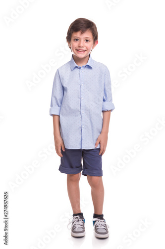 Boy standing smiling on a white background