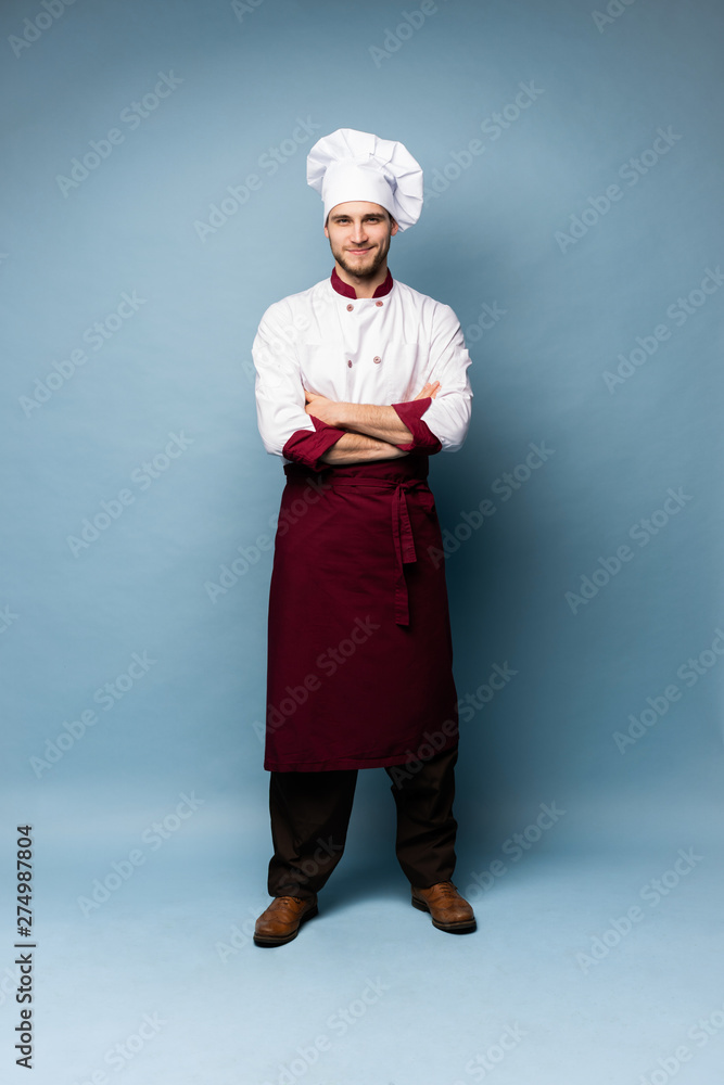 Full length portrait of cheerful joyful chef cook with stubble in beret and white outfit looking at camera isolated Full length portrait of cheerful joyful chef cook with stubble in beret and white outfit looking at camera isolated