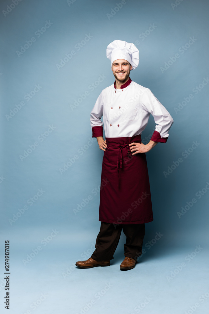 Full length portrait of cheerful joyful chef cook with stubble in beret and white outfit looking at camera isolated Full length portrait of cheerful joyful chef cook with stubble in beret and white outfit looking at camera isolated