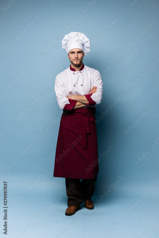 Full length portrait of cheerful joyful chef cook with stubble in beret and white outfit looking at camera isolated Full length portrait of cheerful joyful chef cook with stubble in beret and white outfit looking at camera isolated