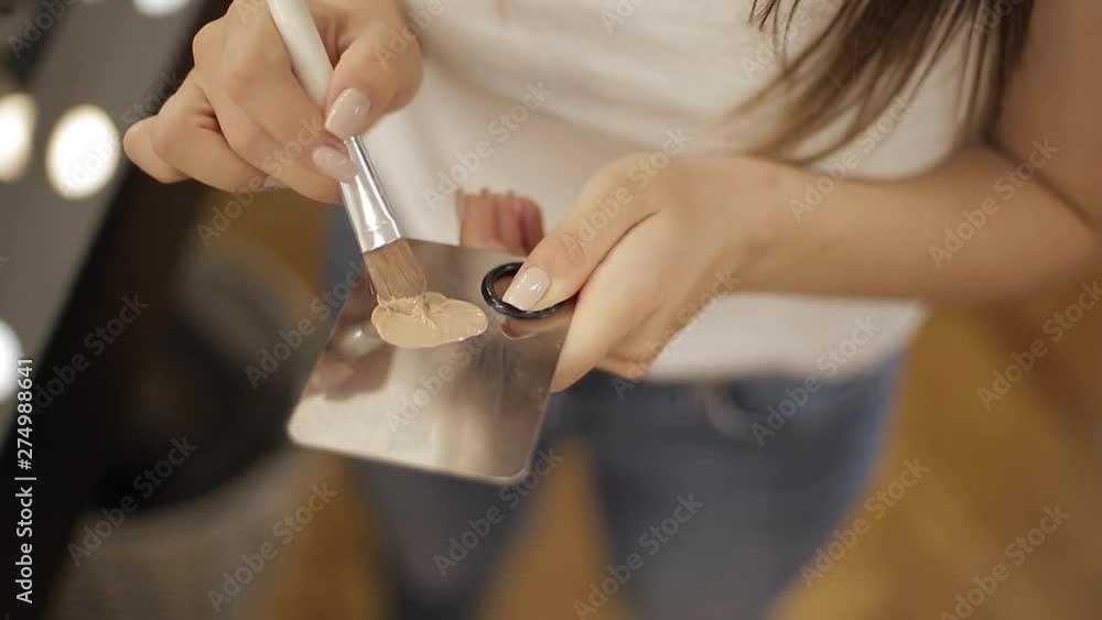 Close up of makeup artist use concealer on putty knife Close up of makeup artist use concealer on putty knife