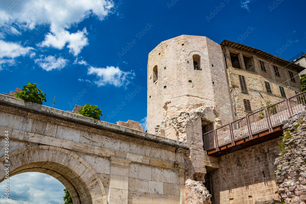 The Porta di Venere, from the Roman era, made of white travertine, with its three arches and the two towers of Properzio. In Spello, province of Perugia, Umbria, Italy.