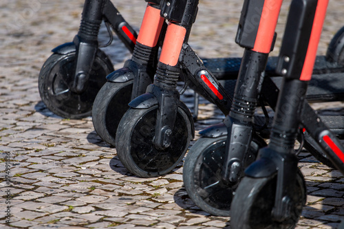 Electric scooters in row on the street.