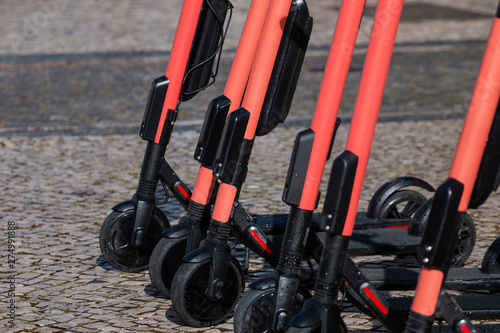 Electric scooters in row on the street.