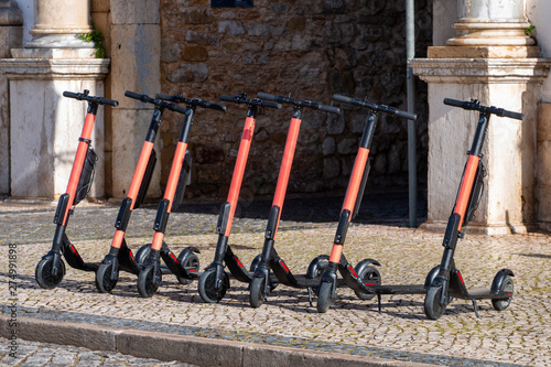 Electric scooters in row on the street.