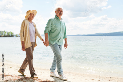 Aged casual man and woman holding by hands