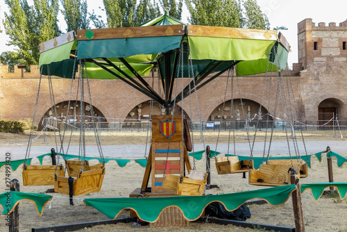 ancient wooden carousel in a medieval festival celebrated in alcala de henares, spain