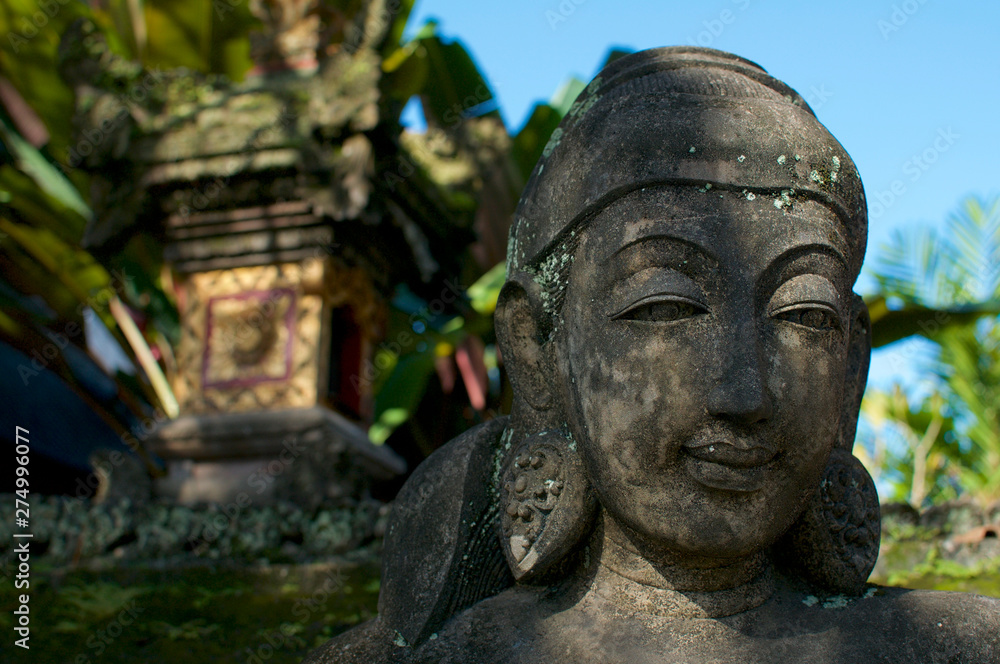 Close up picture of a female like stone statue in Bali