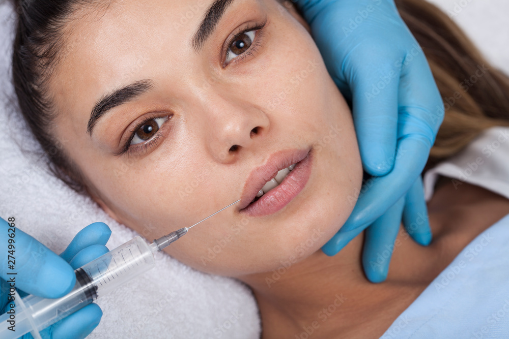 Young woman undergoing procedure of bb glow treatment in beauty salon Young woman undergoing procedure of bb glow treatment in beauty salon